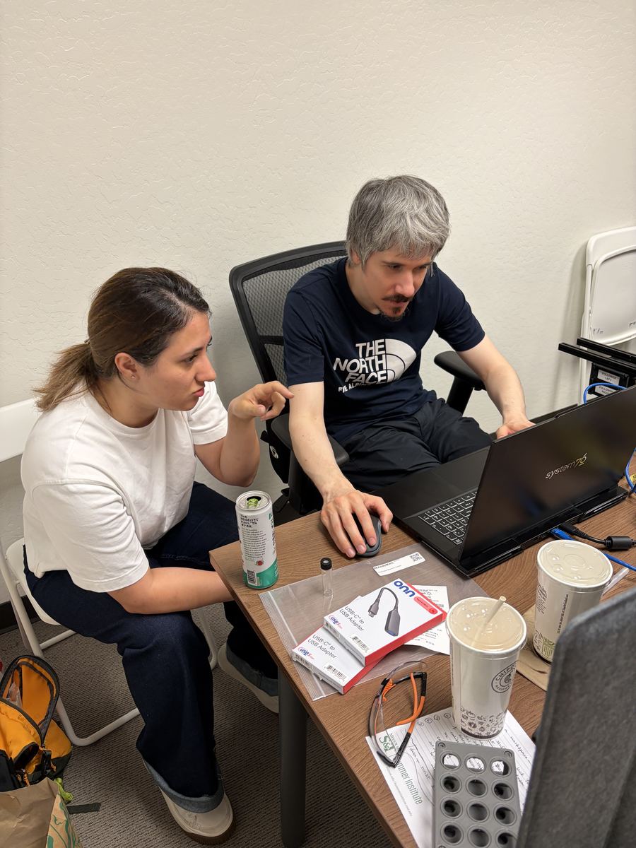 Two team members working together at a laptop.